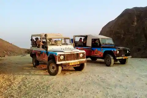 Illustration of jeeps on a desert track with soft dust clouds