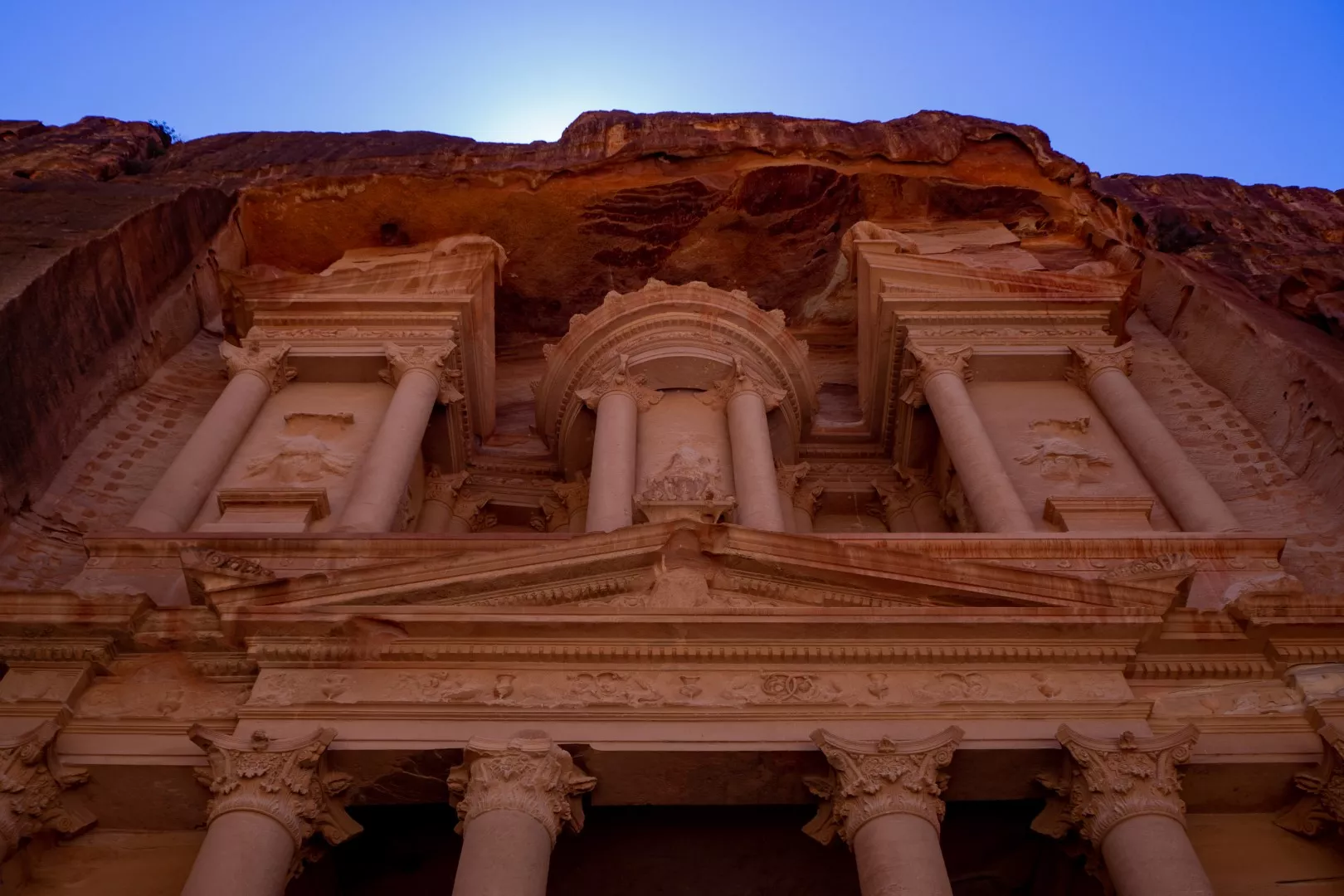 Narrow Siq canyon walls opening to reveal Al-Khazneh the Treasury in Petra